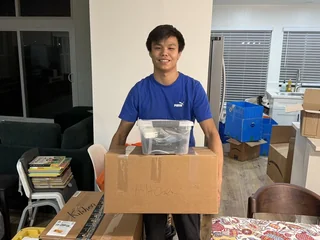 Team member carrying kitchen boxes