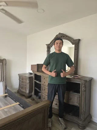 Mover giving thumbs up after furniture assembly