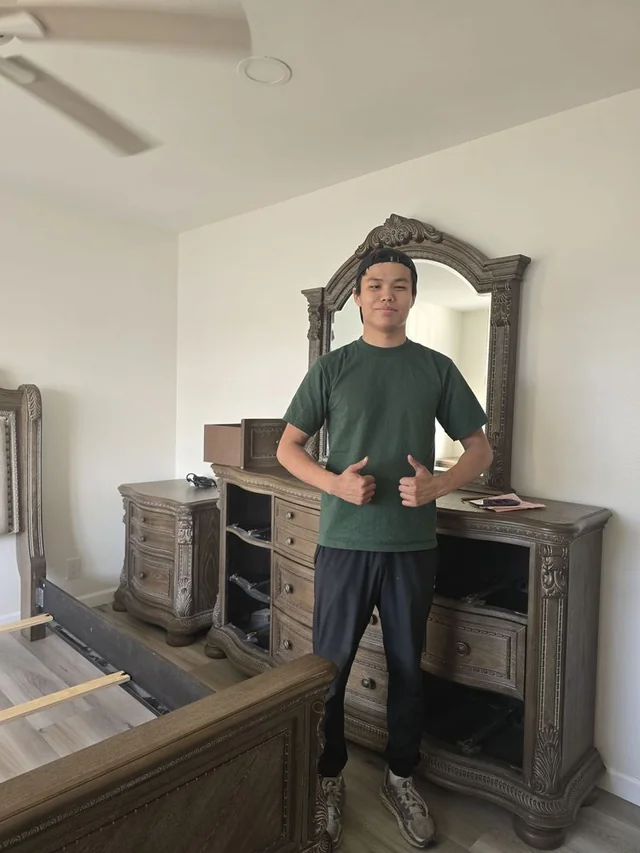 Mover giving thumbs up after successful furniture assembly